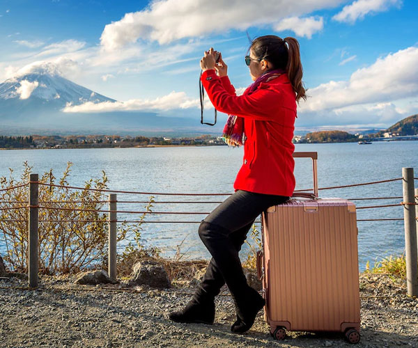 Woman take a photo at fuji mountains. autumn in japan. travel concept.